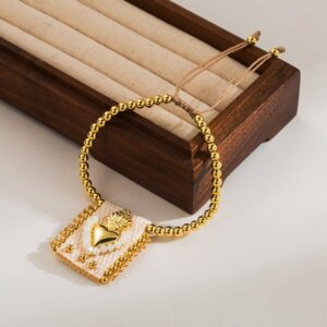 Pulsera dorada chapa de oro corazon blanco